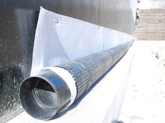 Deckdrain wrapped around perforated carrier pipe