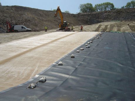 Double lining system installation, GCL and 2mm textured HDPE geomembranes
