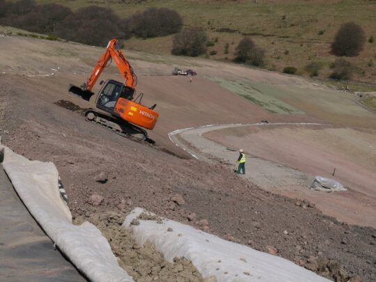 Proving high friction as construction traffic spreads cover soil whilst protecting the geomembrane
