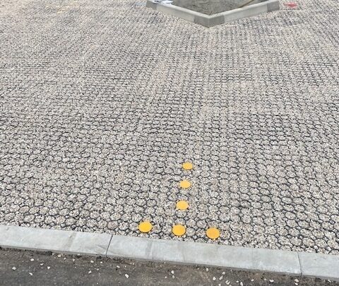 Yellow markers supplied to delineate the car parking bays